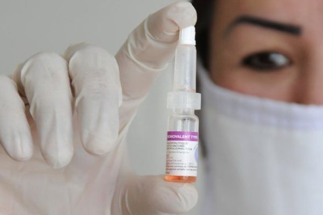 врач в руке держит вакцину